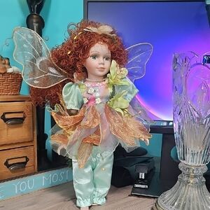 Whimsical Fairy Doll with Auburn Curls and Pastel Outfit